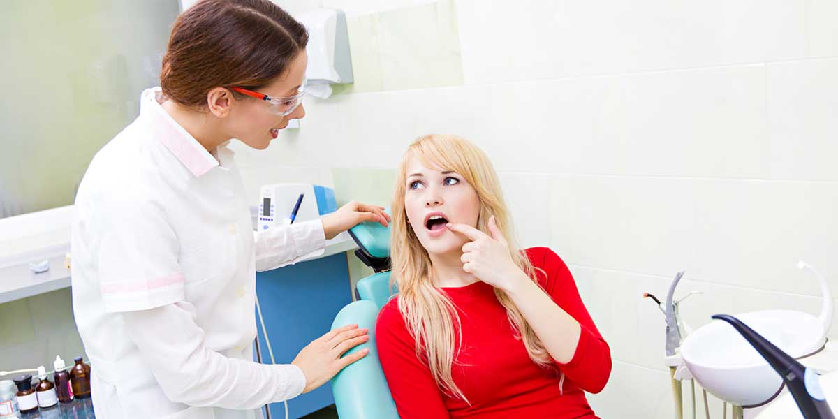Patient is Showing Her Painful Teeth to Doctor